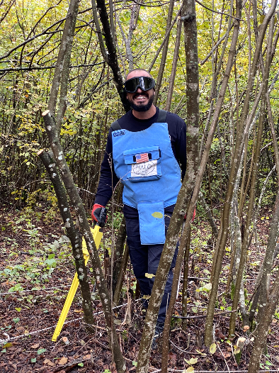 HALO Trust deminer with a Schonstedt in the woods