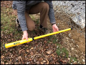 searching in the vicinity of a chain linked fence with a schonstedt magnetic locator spot